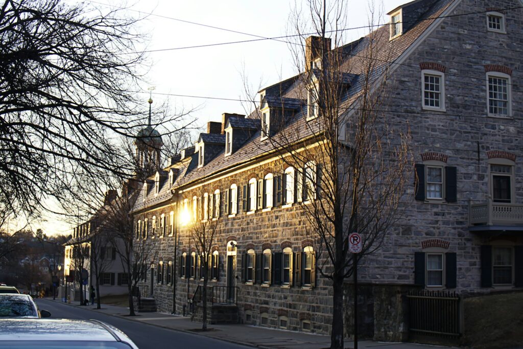 Old stone buildings sit along a quiet street.
